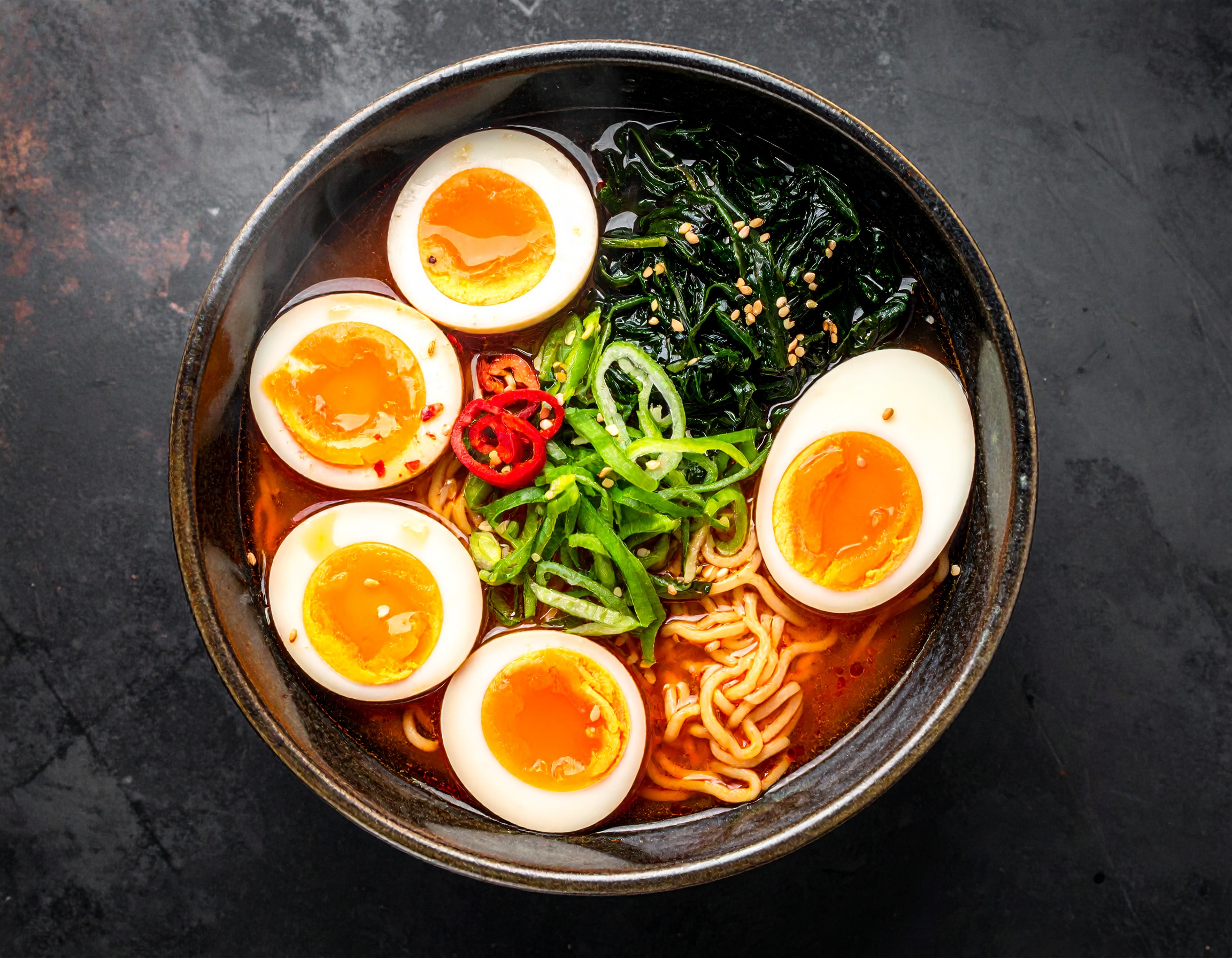 Delicious Ramen Bowl with Soft-Boiled Eggs and Fresh Spinach
